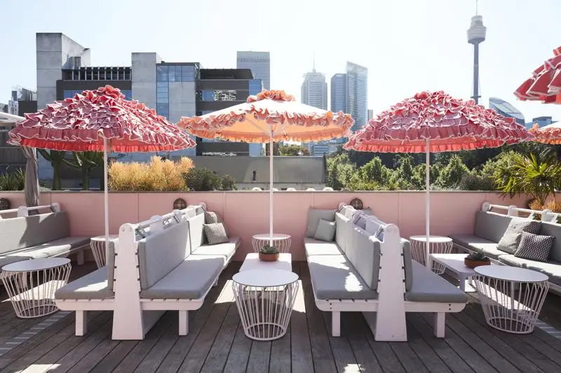 Sydney rooftop bar with city skyline views, cocktails and outdoor terrace seating at sunset.