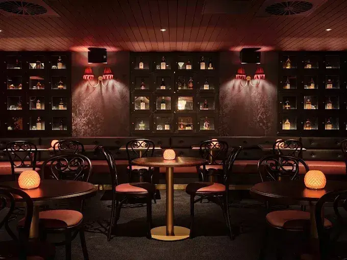Elegant Sydney speakeasy bar with candlelit tables, premium spirits and intimate underground atmosphere.