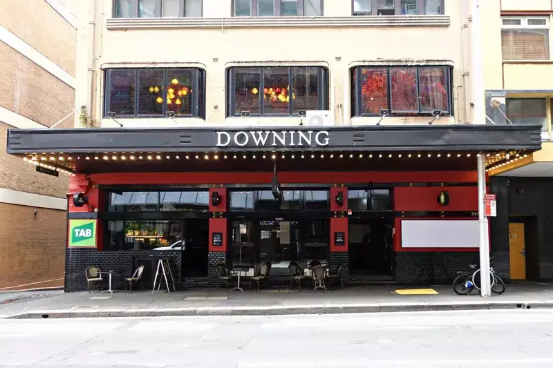 The Downing Hotel on Castlereagh Street in Sydney CBD, featuring its heritage-style façade, pub entrance and outdoor seating area.