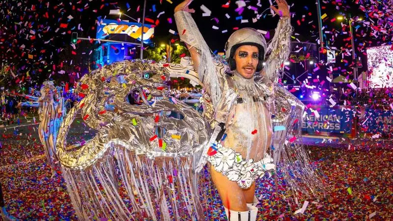 Performer in a silver costume surrounded by confetti at the Sydney Gay and Lesbian Mardi Gras Parade.