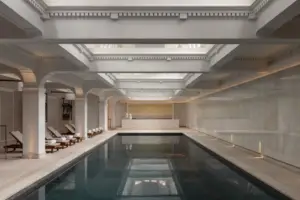 Indoor swimming pool at Capella Sydney, showcasing the hotel's elegant heritage architecture, luxury wellness facilities and refined design.