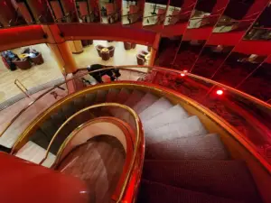Grand spiral staircase inside Stamford Plaza Adelaide, showcasing the hotel's elegant interior design, warm lighting and sophisticated atmosphere.