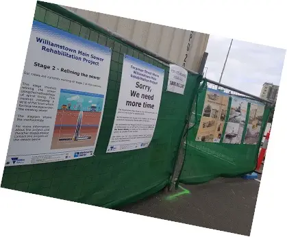 Construction fencing displaying project information, construction updates and historical storytelling panels during Melbourne Water's Williamstown Main Sewer Rehabilitation Project.